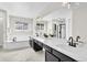 Contemporary bathroom features dual sinks, sleek fixtures, and a soaking tub at 275 S Pembrook St, Castle Rock, CO 80104