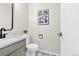 Stylish half bathroom featuring modern fixtures, including a sleek sink and toilet, enhanced by designer flooring and lighting at 275 S Pembrook St, Castle Rock, CO 80104