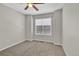 Empty bedroom with neutral paint color, large window, and ceiling fan at 275 S Pembrook St, Castle Rock, CO 80104