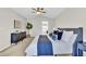 Well-lit bedroom with ceiling fan, ensuite bathroom, and a stylish dresser at 275 S Pembrook St, Castle Rock, CO 80104
