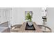 The bright dining area features light hardwood floors and a wooden table and chairs with a decorative centerpiece at 275 S Pembrook St, Castle Rock, CO 80104