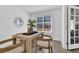 Cozy dining area with a decorative centerpiece on a wooden table, adjacent to a window with bright, natural light at 275 S Pembrook St, Castle Rock, CO 80104