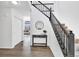 Inviting entryway features hardwood floors, a staircase with black railings, and a decorative table with a round mirror above it at 275 S Pembrook St, Castle Rock, CO 80104