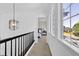 Upper hallway leads to bedroom with natural light and modern touches; adds to the contemporary flow of the home at 275 S Pembrook St, Castle Rock, CO 80104