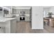 Well-lit, modern kitchen with light grey cabinets, stainless steel appliances, and a kitchen island with bright marble countertop at 275 S Pembrook St, Castle Rock, CO 80104