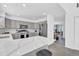 Stylish kitchen boasts a white marbled island countertop, complemented by light gray cabinetry and modern appliances at 275 S Pembrook St, Castle Rock, CO 80104