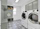 Well-organized laundry room with modern washer, dryer, storage, and designer tile, combining functionality and style at 275 S Pembrook St, Castle Rock, CO 80104