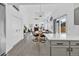 Open-concept living room boasts high ceilings, a fireplace, and large windows, seamlessly connecting to the kitchen and dining area at 275 S Pembrook St, Castle Rock, CO 80104
