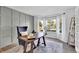 Bright office with a grid accent wall, a large window with white curtains, and a cozy chair next to the desk at 275 S Pembrook St, Castle Rock, CO 80104