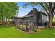 Expansive backyard featuring a large lawn, mature trees, deck, and landscaped garden beds at 4269 Carter Trl, Boulder, CO 80301