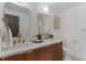 Bathroom with a double sink vanity with a patterned wood cabinet, gold hardware, and gold-framed mirrors at 4269 Carter Trl, Boulder, CO 80301