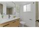 Bathroom with a single sink vanity with a light cabinet, matte black hardware, mirror, and modern fixtures at 4269 Carter Trl, Boulder, CO 80301