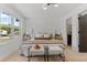 Bright bedroom with a window, upholstered bed frame, chair and two benches with a soft carpet at 4269 Carter Trl, Boulder, CO 80301