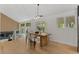 Bright dining room with hardwood floors, an elegant dining table, and multiple windows at 4269 Carter Trl, Boulder, CO 80301