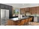 Modern kitchen featuring stainless appliances, a kitchen island with bar stool seating, and dark countertops at 4269 Carter Trl, Boulder, CO 80301