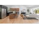 Open concept living room and kitchen space with stainless appliances, bar stool seating, and modern decor at 4269 Carter Trl, Boulder, CO 80301