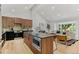 Open concept kitchen and living room with stainless appliances, a kitchen island, and barstool seating at 4269 Carter Trl, Boulder, CO 80301