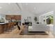 Modern living room with vaulted ceilings, hardwood floors, and an open concept design to the kitchen and a large bay window at 4269 Carter Trl, Boulder, CO 80301