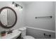 Bathroom with a round mirror and a sink with oil rubbed bronze fixtures at 11645 Lincoln St, Northglenn, CO 80233