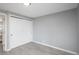 This is a bedroom with wood-look floors and a closet with white sliding doors at 11645 Lincoln St, Northglenn, CO 80233
