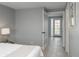 Bedroom with neutral decor and hardwood floors, leading to a door with a deck view at 11645 Lincoln St, Northglenn, CO 80233