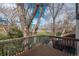 View from the deck surrounded by mature trees with a park in the distance at 11645 Lincoln St, Northglenn, CO 80233