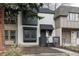 Charming two-story townhome featuring a combination of white painted brick and muted siding and a front porch at 11645 Lincoln St, Northglenn, CO 80233