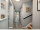 Bright hallway with wood-look tile floors, leading to a door with backyard view at 11645 Lincoln St, Northglenn, CO 80233