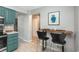 Cozy kitchen with blue cabinets and a breakfast bar featuring modern black stools at 11645 Lincoln St, Northglenn, CO 80233