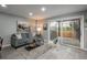Inviting living room featuring light gray walls, wood-look floors, and sliding glass doors to backyard at 11645 Lincoln St, Northglenn, CO 80233