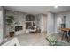 Bright and airy living room with a fireplace, built-in shelving, and an open doorway at 11645 Lincoln St, Northglenn, CO 80233