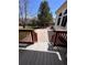 A view of the home's backyard, taken from the elevated deck with stairs leading to a concrete patio and fenced yard at 11506 Greenbriar Ln, Parker, CO 80138