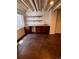 Basement features a bar area with custom shelves and cabinets, sink, and modern flooring for entertaining at 11506 Greenbriar Ln, Parker, CO 80138