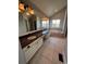 This bathroom features a soaking tub, granite countertop, and double sinks beneath a large mirror at 11506 Greenbriar Ln, Parker, CO 80138