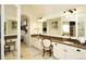 Spacious bathroom with double vanity, large mirror, and plenty of natural light at 11506 Greenbriar Ln, Parker, CO 80138