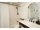 Stylish bathroom with a white subway tile shower and a vanity with a decorative mirror at 11506 Greenbriar Ln, Parker, CO 80138