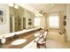 Bright bathroom with granite countertops, double sinks, soaking tub, and stylish decor at 11506 Greenbriar Ln, Parker, CO 80138