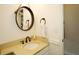 Updated bathroom with a stone countertop, vessel sink, and decorative mirror at 11506 Greenbriar Ln, Parker, CO 80138