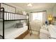 Shared bedroom with a bunk bed, crib, and cozy seating area at 11506 Greenbriar Ln, Parker, CO 80138