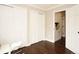 Bedroom showing a hardwood floor with closets on the left and a doorway on the right at 11506 Greenbriar Ln, Parker, CO 80138