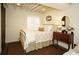 Charming bedroom featuring a metal bed frame, dark brown floors, and a dresser with decor at 11506 Greenbriar Ln, Parker, CO 80138