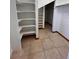 This walk-in closet has custom shelving, tile floor, and offers lots of storage space at 11506 Greenbriar Ln, Parker, CO 80138