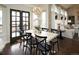 Dining room featuring a chandelier, six chairs, and a glass patio door leading to the outside at 11506 Greenbriar Ln, Parker, CO 80138