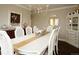 Elegant dining room with a white table, wicker chairs, chandelier, and decor for an inviting atmosphere at 11506 Greenbriar Ln, Parker, CO 80138