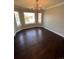 Formal dining room featuring dark wood floors, chandelier, and bright windows at 11506 Greenbriar Ln, Parker, CO 80138