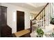 Inviting foyer with a dark wooden door, hardwood floors, and a staircase leading to the upper level at 11506 Greenbriar Ln, Parker, CO 80138