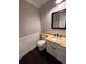 Cozy half bathroom featuring modern fixtures, wood floors, and decorative wainscoting at 11506 Greenbriar Ln, Parker, CO 80138