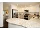Spacious kitchen with granite countertops, stainless steel appliances, and wooden floors for a modern and functional space at 11506 Greenbriar Ln, Parker, CO 80138