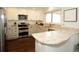 Beautiful kitchen with granite countertops, modern appliances, and wooden floors for a stylish and functional space at 11506 Greenbriar Ln, Parker, CO 80138