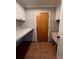 Functional laundry room with white cabinets, ample countertop space, and a utility sink at 11506 Greenbriar Ln, Parker, CO 80138